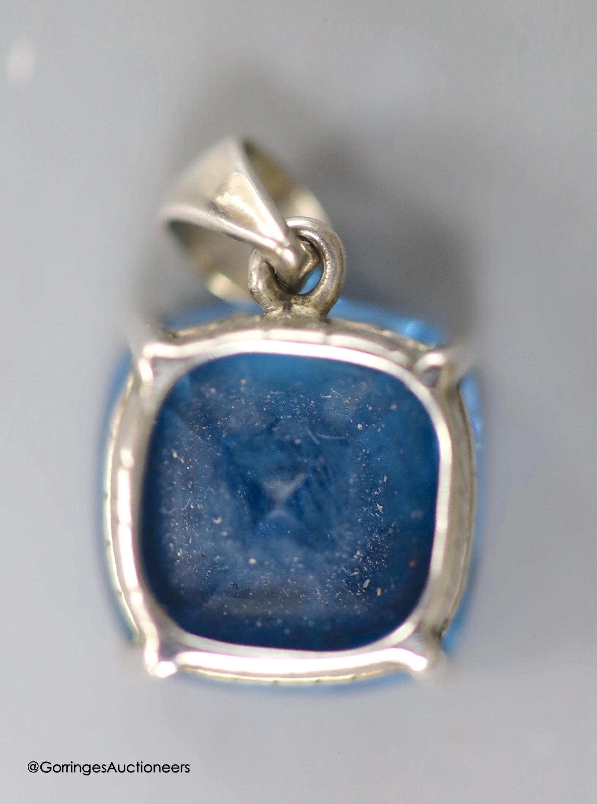 A white metal mounted square cushion cut blue topaz pendant